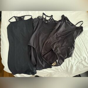 Lot of 2 black leotards and 1 black biketard